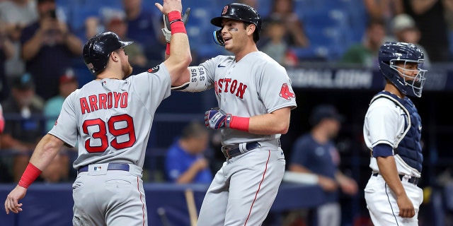 Boston Red Sox's Triston Casas, center, is congratulated by Christian Arroyo on his two-run home run, next to Tampa Bay Rays catcher Francisco Mejia during the second inning of a baseball game Tuesday, Sept. 6, 2022, in St. Petersburg, Florida.