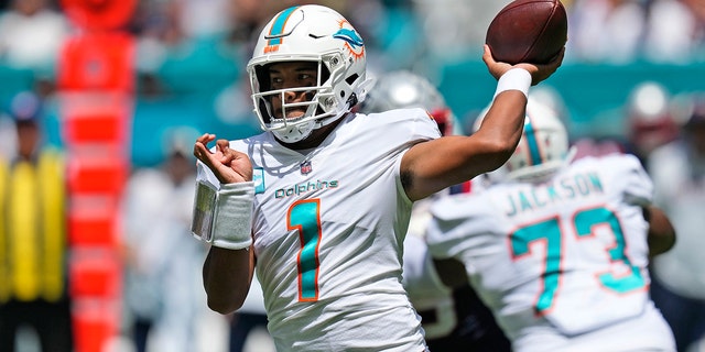 Miami Dolphins quarterback Tua Tagovailoa (1) aims a pass during the first half of an NFL football game against the New England Patriots, Sunday, Sept. 11, 2022, in Miami Gardens, Fla.