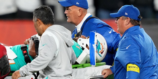 Sep 29, 2022;  Cincinnati, Ohio, USA;  Miami Dolphins quarterback Tua Tagovailoa (1) is taken off the field after suffering a head injury following a sack by Cincinnati Bengals defensive tackle Josh Tupou (not pictured) in the second quarter at Paycor Stadium in Cincinnati.