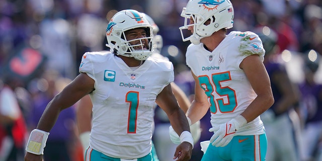 Miami Dolphins quarterback Tua Tagovailoa and wide receiver River Cracraft celebrate a touchdown against the Ravens, Sept. 18, 2022, in Baltimore.