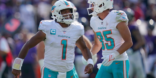 Miami Dolphins quarterback Tua Tagovailoa and wide receiver River Cracraft celebrate a touchdown against the Ravens, Sept. 18, 2022, in Baltimore.