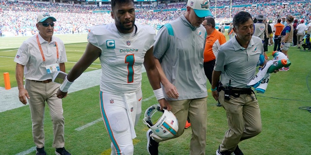 Miami Dolphins quarterback Tua Tagovailoa (1) is assisted off the field after he was injured during the first half of an NFL football game against the Buffalo Bills, Sunday, Sept. 25, 2022, in Miami Gardens, Fla.