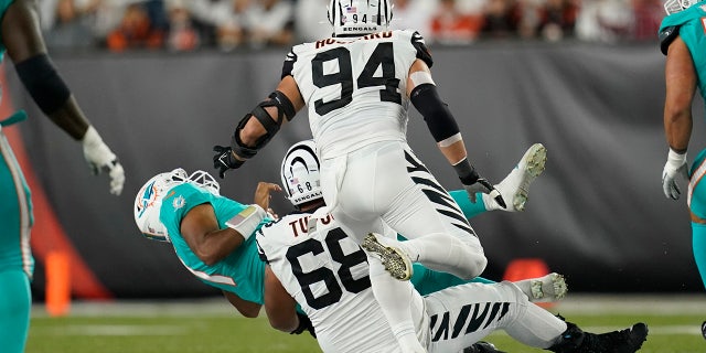 Miami Dolphins quarterback Tua Tagovailoa (1) is sacked by Cincinnati Bengals' Josh Tupou (68) during the first half of an NFL football game, Thursday, Sept. 29, 2022, in Cincinnati. 