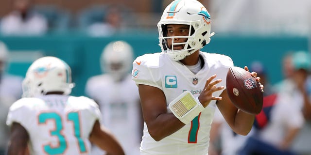 Quarterback Tua Tagovailoa #1 of the Miami Dolphins lays on the turf during the first half of the game against the Buffalo Bills at Hard Rock Stadium on Sept. 25, 2022 in Miami Gardens, Florida.