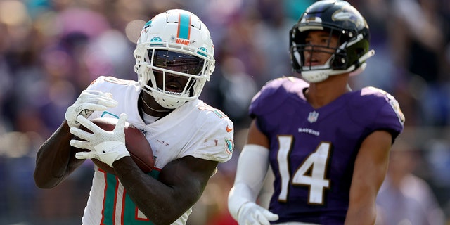 Wide receiver Tyreek Hill of the Miami Dolphins catches a second half touchdown pass in front of Ravens safety Kyle Hamilton on Sept. 18, 2022, in Baltimore.