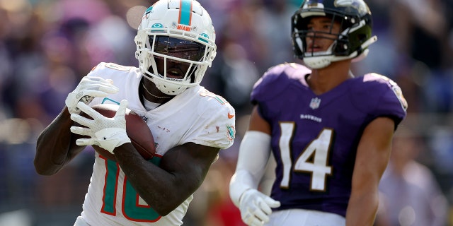 Wide receiver Tyreek Hill of the Miami Dolphins catches a second half touchdown pass in front of Ravens safety Kyle Hamilton on Sept. 18, 2022, in Baltimore.