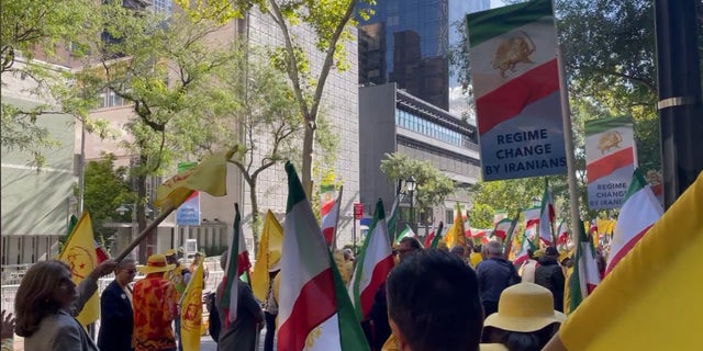 People gather in Dag Hammarskjold Park across the street from the U.N. headquarters to protest Iranian President Ebrahim Raisi, who addressed the General Assembly on Wednesday. 