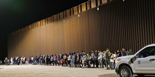 Migrants attempting to cross in to the U.S. from Mexico are detained by U.S. Customs and Border Protection at the border August 20, 2022, in San Luis, Arizona. 
