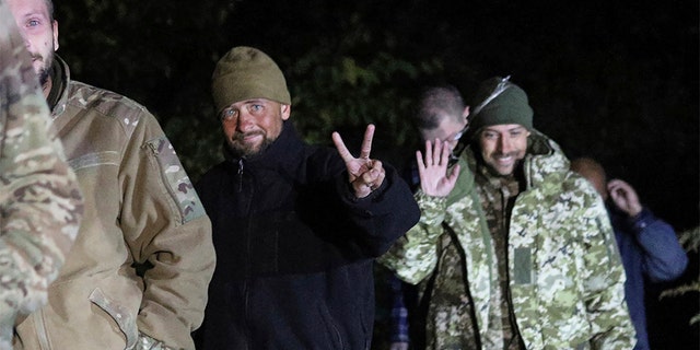 Ukrainian soldiers, who were released in a prisoner exchange between Russia and Ukraine, smile close to Chernihiv, Ukraine, late Wednesday, Sept. 21, 2022. 