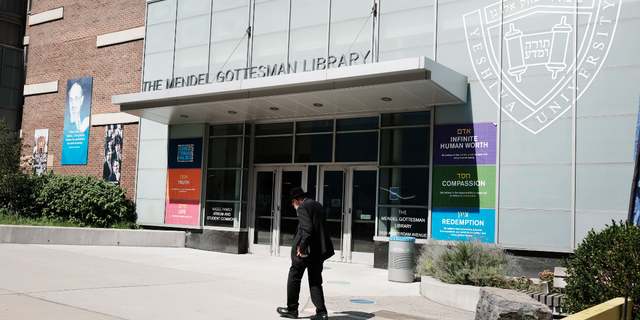 People walk by the campus of Yeshiva University in New York City.