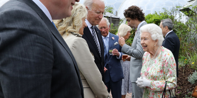 Britain's Queen Elizabeth II (R) speaks with US President Joe Biden and US First Lady Jill Biden and leaders of the G7 during a reception at The Eden Project in south west England on June 11, 2021.
