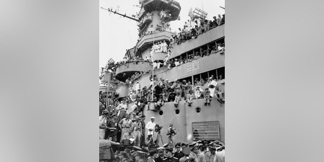 Spectators and photographers pick vantage spots on the deck of the USS Missouri in Tokyo Bay, Japan, to witness the formal Japanese surrender proceedings on Sept. 2, 1945.