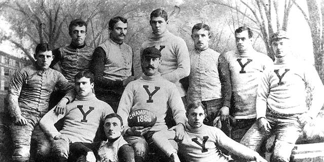 Yale University's 1888 football team, coached by Walter Camp, went 13-0 and outscored its opposition 694-0. Pudge Heffelfinger (back row, center) towered over his teammates. 