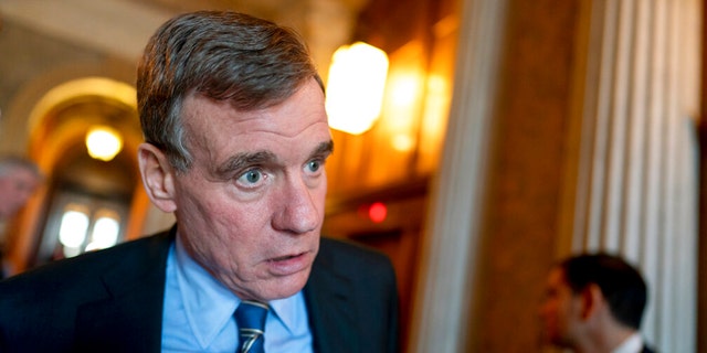 FILE: Senate Intelligence Committee Chairman Mark Warner, D-Va., speaks to a reporter at the Capitol in Washington, March 16, 2022.