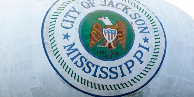 A water tower emblazoned with the City of Jackson, Miss., official seal looms over this north Jackson neighborhood Wednesday, Aug. 31, 2022.