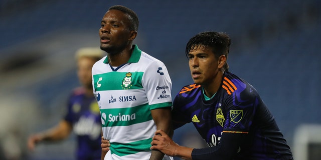 Juan Otero #7 of Santos Laguna and Xavier Arreaga #3 of Seattle Sounders FC fight for position during the semi-final Leagues Cup between Seattle Sounders FC and Santos Laguna at Lumen Field on Sept. 14, 2021 in Seattle, Washington.