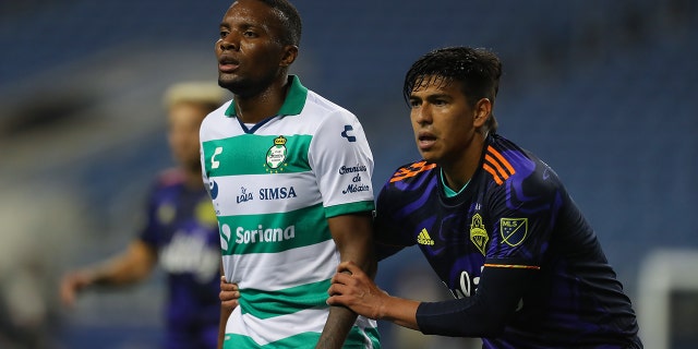 Juan Otero #7 of Santos Laguna and Xavier Arreaga #3 of Seattle Sounders FC fight for position during the semi-final Leagues Cup between Seattle Sounders FC and Santos Laguna at Lumen Field on Sept. 14, 2021 in Seattle, Washington.