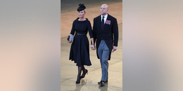 Zara Tindall and husband Mike Tindall walk in procession with Britain's Queen Elizabeth's coffin.  Zara is the daughter of Princess Anne.