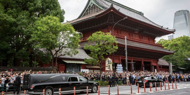 Pictured: A car carrying the body of former Japanese Prime Minister Shinzo Abe leaves Zojoji temple in Tokyo, Japan, on July 12, 2022.