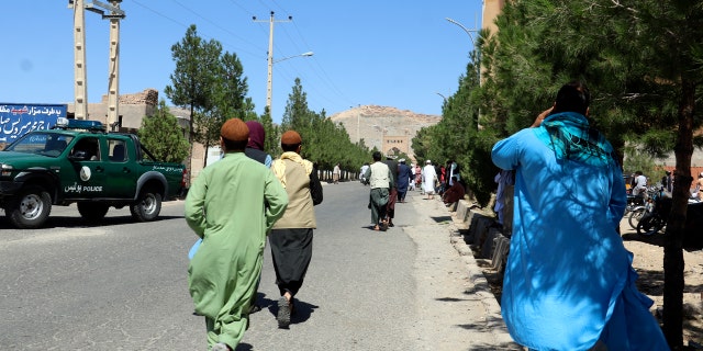 Afghan people run near the site of an explosion in Herat province, Afghanistan, Friday, Sept 2, 2022.