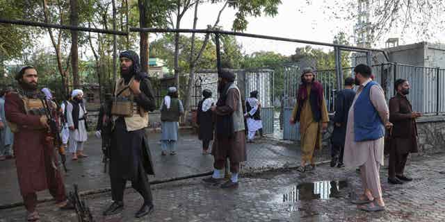 Taliban soldiers investigate the site of a suspected bombing near a mosque in Wazir Akbar Khan in Kabul on Sept. 23, 2022.
