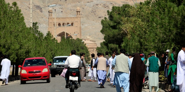 Afghan people gather near the site of an explosion in Herat province, Afghanistan, Friday, Sept 2, 2022. Taliban officials and a local medic say an explosion tore through a crowded mosque in western Afghanistan, killing more than a dozen of people, including a prominent cleric. (AP Photo/Omid Haqjoo)