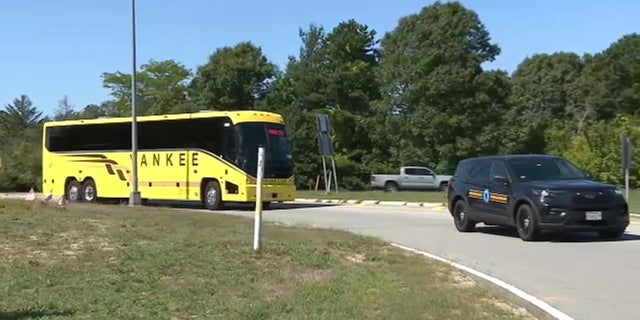 A bus carrying migrants sent to Martha's Vineyard arrives at Joint Base Cape Cod in Massachusetts on Friday.