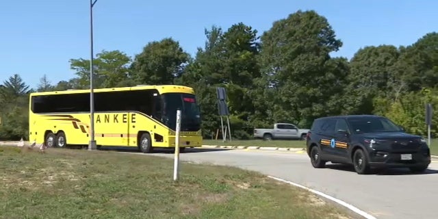 A bus carrying migrants sent to Martha's Vineyard arrives at Joint Base Cape Cod in Massachusetts, Friday, Sept. 16, 2022.