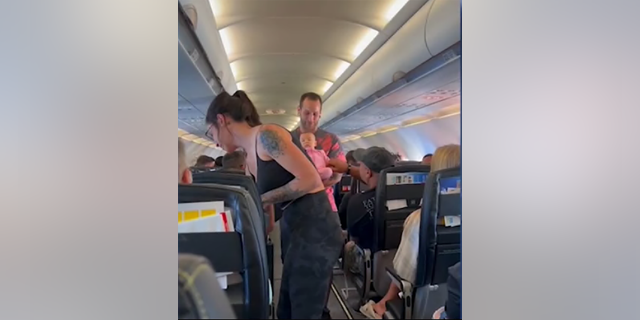 The parents of three-month-old, Anjelé, return to their seats after a nurse on board saved their daughter's life.