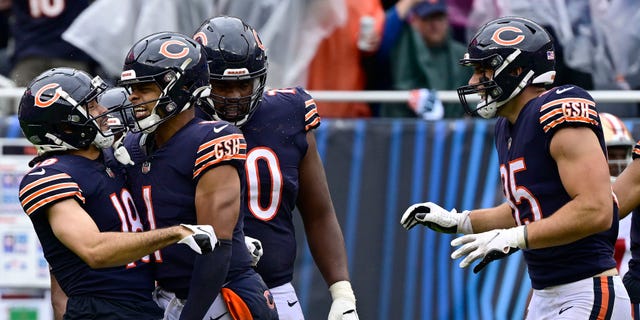 Bears wide receiver Dante Pettis, left, celebrates with quarterback Justin Fields after a touchdown against the San Francisco 49ers at Soldier Field on September 11, 2022 in Chicago.