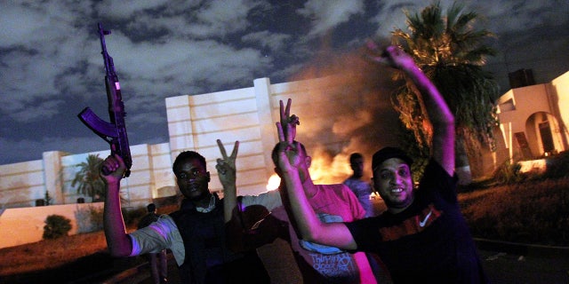 Protesters expel members of the hardline Islamist group Ansar el-Sharia from their base in Benghazi, Libya, on September 21, 2012. The mob set fire to at least one vehicle on the premises.