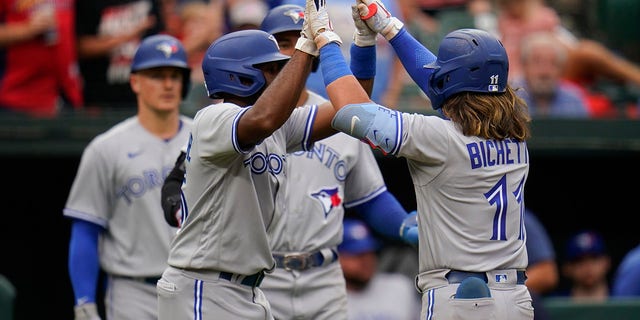 Beau Bichett (right) and Jackie Bradley Jr. (left) of the Toronto Blue Jays beat the Baltimore Orioles after Bichett hit a three-run homer in the third inning of the second game of a baseball doubleheader. Right, celebrating with Jackie Bradley Jr. after hitting relief pitcher Nick Vespi.  Baltimore, May 5, 2022. Bradley Jr. and teammate George Springer scored on home runs.