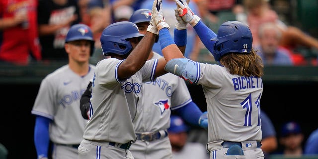 Beau Bichett (right) and Jackie Bradley Jr. (left) of the Toronto Blue Jays beat the Baltimore Orioles after Bichett hit a three-run homer in the third inning of the second game of a baseball doubleheader. Right, celebrating with Jackie Bradley Jr. after hitting relief pitcher Nick Vespi.  Baltimore, May 5, 2022. Bradley Jr. and teammate George Springer scored on home runs.