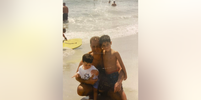 Matthew Bocchi, left, at the beach with his dad and brother Michael, right.