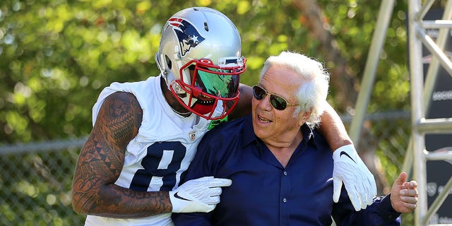 New England Patriots owner Robert Kraft gets a hug from wide receiver Kendrick Bourne at the start of training camp.