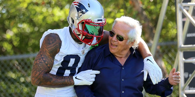 New England Patriots owner Robert Kraft gets a hug from wide receiver Kendrick Bourne at the start of training camp.