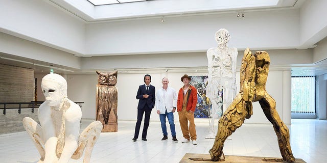 British artist Thomas Houseago poses with Brad Pitt and Australian musician Nick Cave.