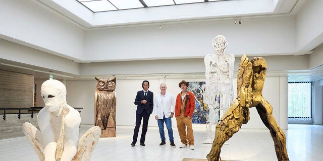 British artist Thomas Houseago poses with Brad Pitt and Australian musician Nick Cave.