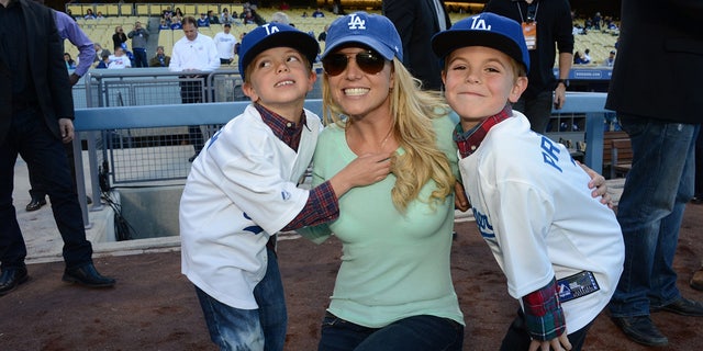 Britney Spears poses with her sons Jayden James Federline (left) and Sean Preston Federline (right) during a 2013 Dodger game.