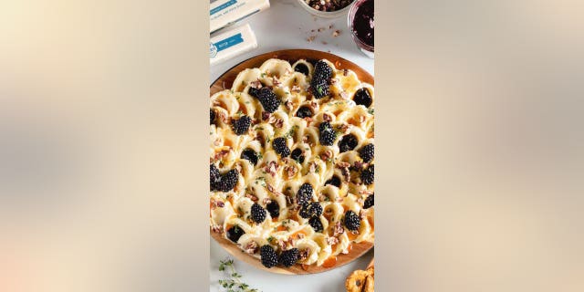 This unique butter board includes blackberry jam, berries, honey and salt.