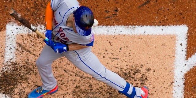The New York Mets' Mark Canha is hit by a pitch during the fifth inning of a game against the Milwaukee Brewers Wednesday, Sept. 21, 2022, in Milwaukee.