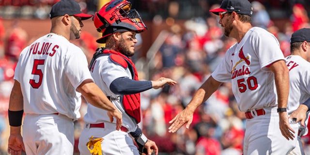 Albert Pujols (5), Yadier Molina (Center) and Adam Wainwright of the St. Louis Cardinals celebrate after a game at Busch Stadium in St. Louis, Missouri on August 4, 2022.