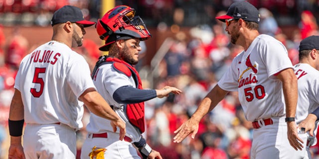 Albert Pujols (5), Yadier Molina (4) and Adam Wainwright (50) of the St. Louis Cardinals celebrate after a game at Busch Stadium on August 4, 2022 in St. Louis.
