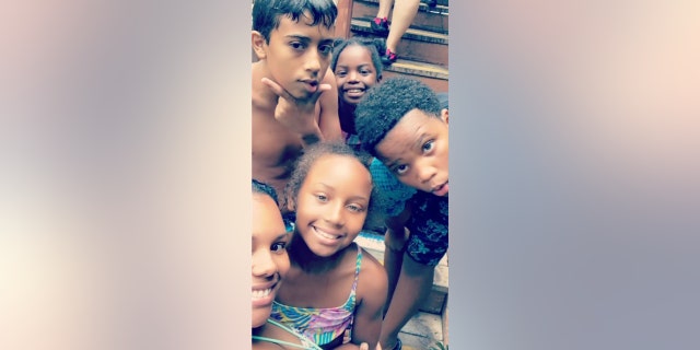 Stefanie Whitley (front left, in foreground) poses with four of her five children.