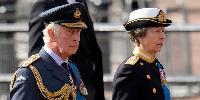 Britain's King Charles III, left, and Princess Anne follow the coffin of Queen Elizabeth II during a procession from Buckingham Palace to Westminster Hall.