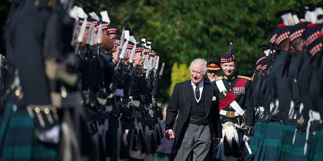 King Charles III inspects the honor guard as they arrive to attend the key ceremony at the Palace of Holyroodhouse in Edinburgh on Monday 12 September 2022.