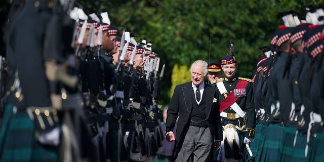 King Charles III inspects the honor guard as they arrive to attend the key ceremony at the Palace of Holyroodhouse in Edinburgh on Monday 12 September 2022.