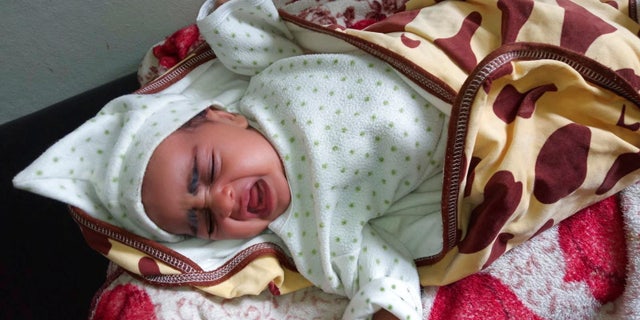 A child infected with whooping cough cries in his crib in Ethiopia on Sept. 9, 2022, as deadly childhood diseases tear through Ethiopia's Tigray region.