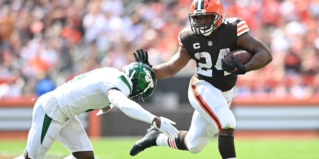 Cleveland Browns' Nick Chubb (24) runs with the ball before being tackled by New York Jets' DJ Reid during the first quarter at FirstEnergy Stadium on September 18, 2022 in Cleveland.