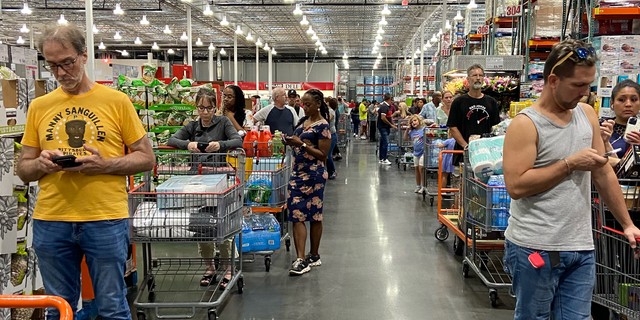 Customers wait in long lines at a Costco in Orlando, Florida on Friday, September 23, 2022, ahead of Tropical Storm Ian.